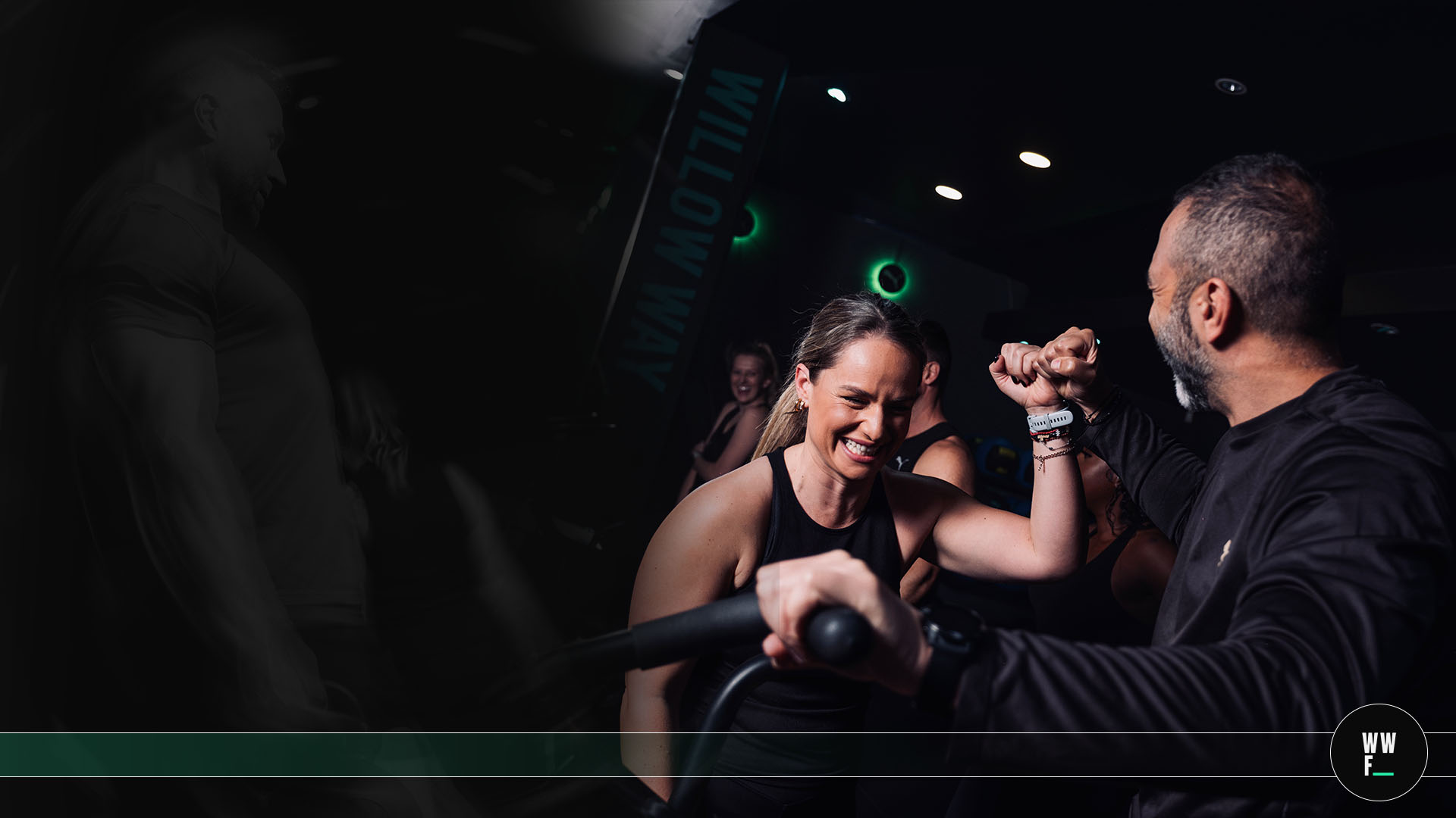 Willow Way Fitness member and coach fist bumping during a class